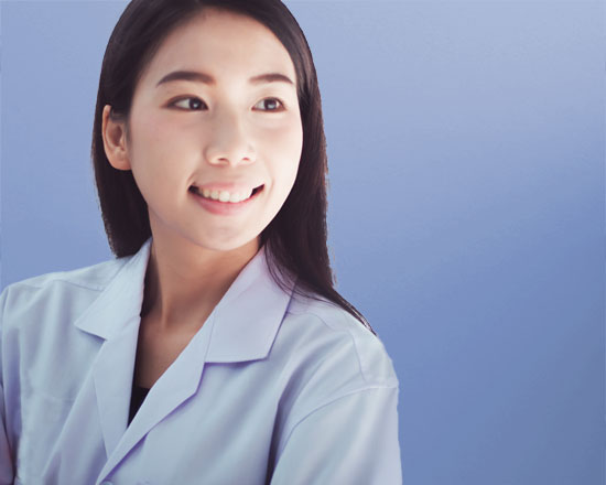 smiling female pharmacist in white lab coat