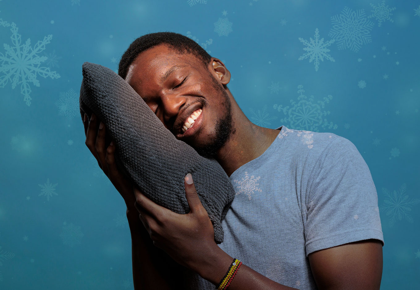 man sleeping while holding a pillow