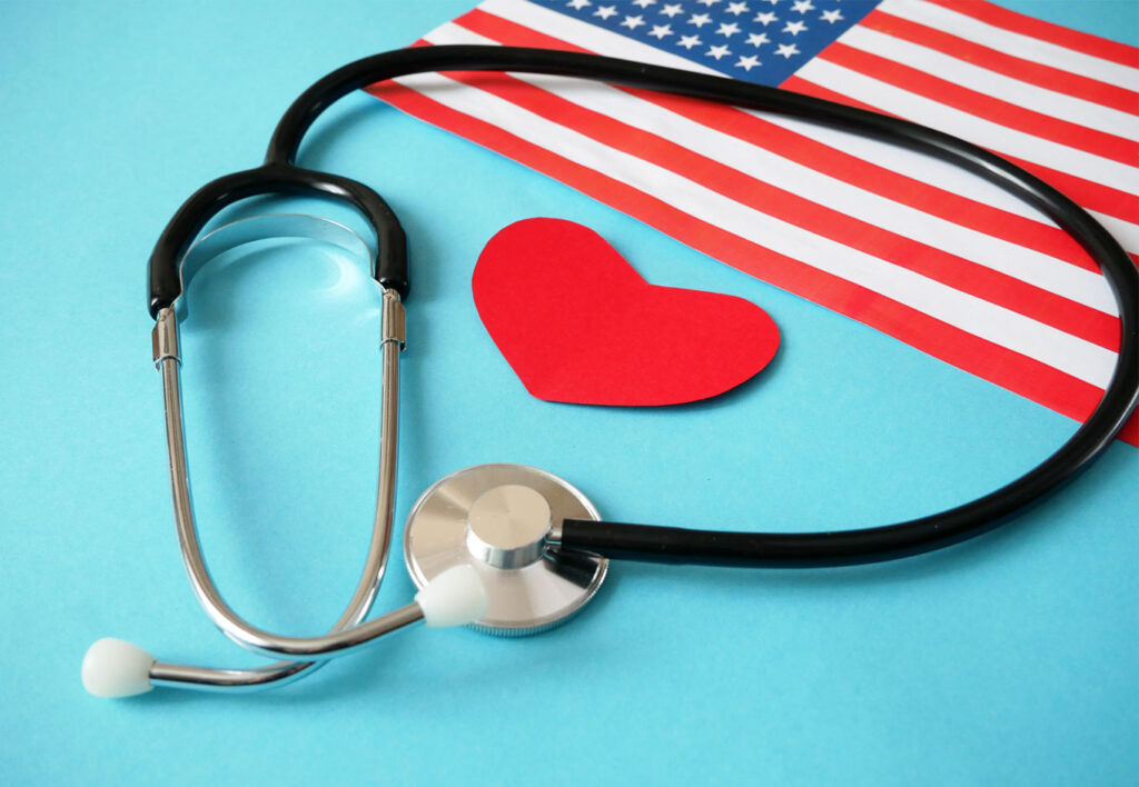 American flag with a heart and stethoscope, blue backdrop